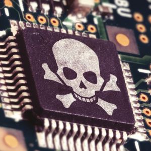 A close up of a computer chip with a skull and crossbones depicted on it
