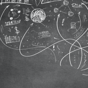 Chalkboard with business analytics graphics written artfully across it.